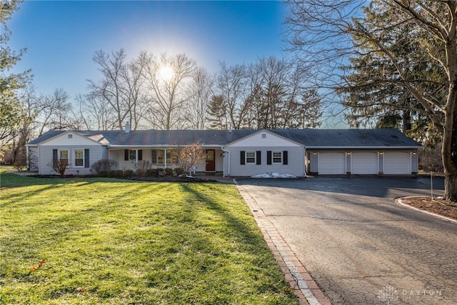 single story home featuring a garage and a front yard