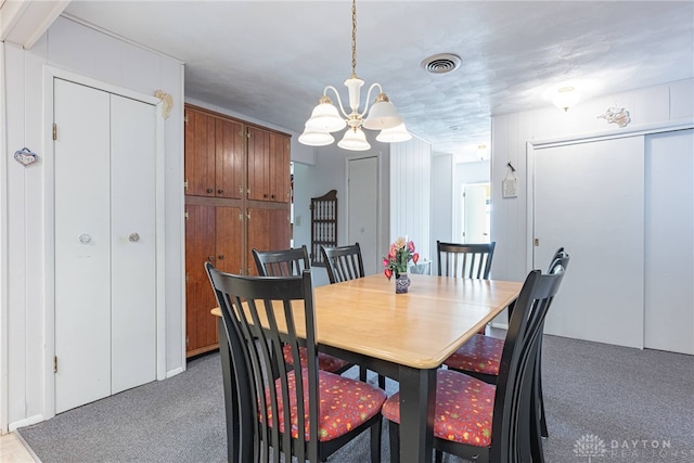 dining space featuring an inviting chandelier