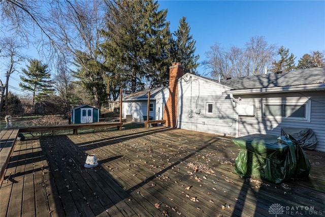 wooden deck featuring a storage unit