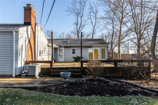 rear view of house with central AC unit and a wooden deck