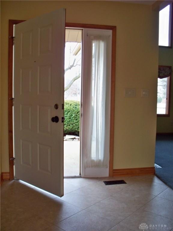 foyer featuring light tile patterned floors