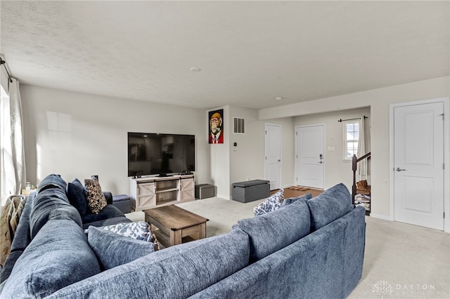 living room with light colored carpet and a textured ceiling