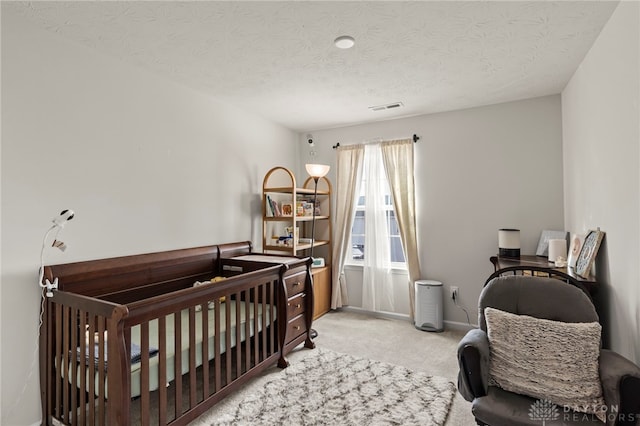 carpeted bedroom featuring a textured ceiling