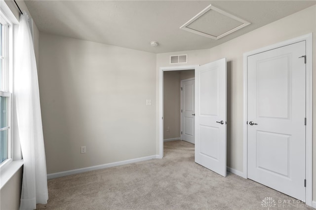 unfurnished bedroom featuring light colored carpet