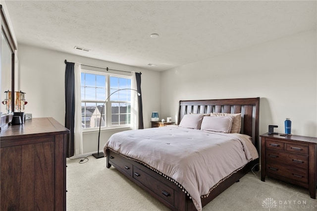 carpeted bedroom featuring a textured ceiling