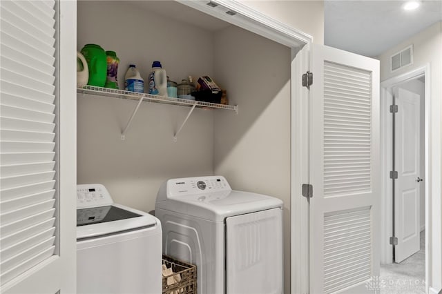 clothes washing area featuring washing machine and clothes dryer