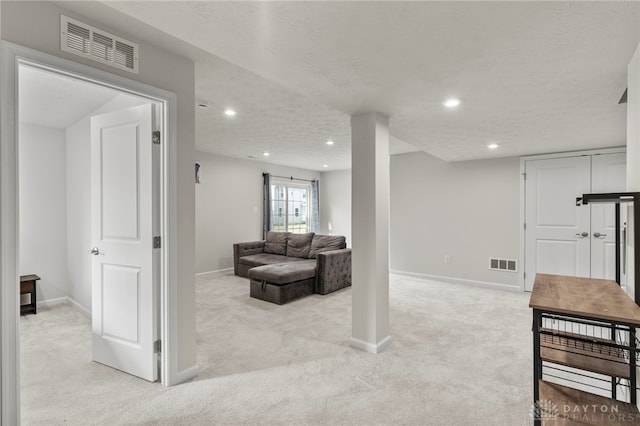 carpeted living room with a textured ceiling