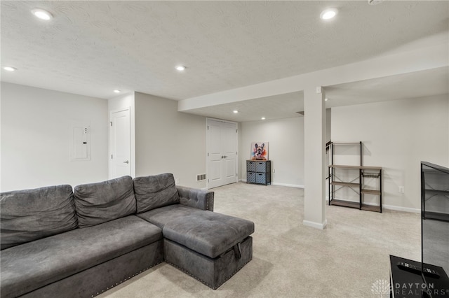 carpeted living room with a textured ceiling