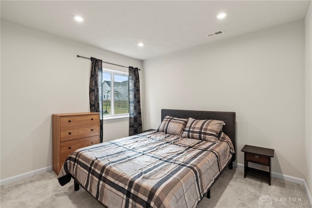 bedroom featuring light carpet