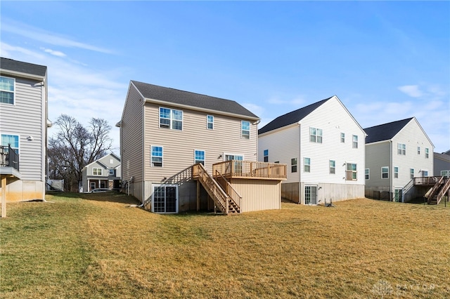 back of property featuring a deck and a lawn