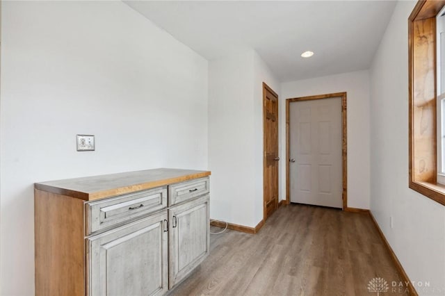 corridor with light hardwood / wood-style flooring