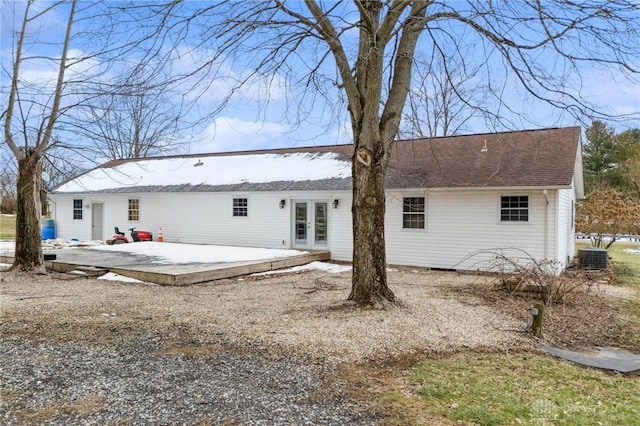 rear view of house with french doors, central AC, and a patio area