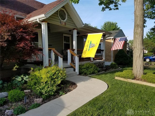 property entrance featuring a porch and a yard