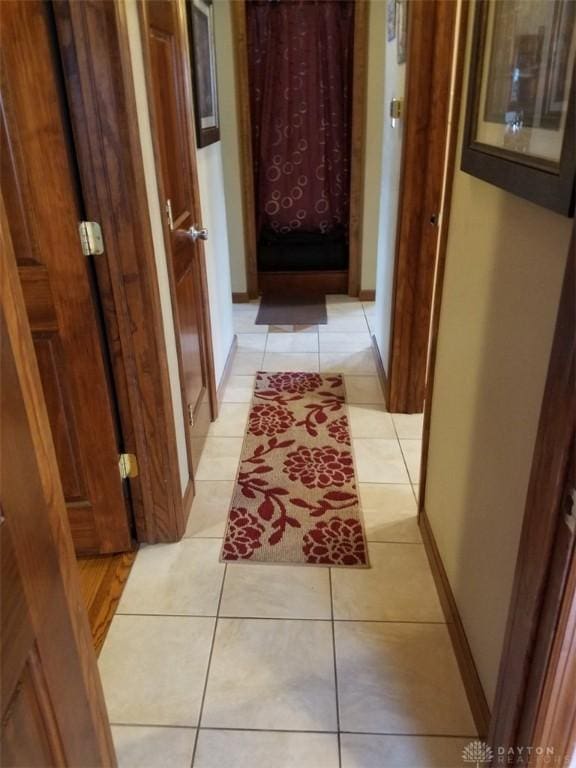 corridor featuring light tile patterned floors