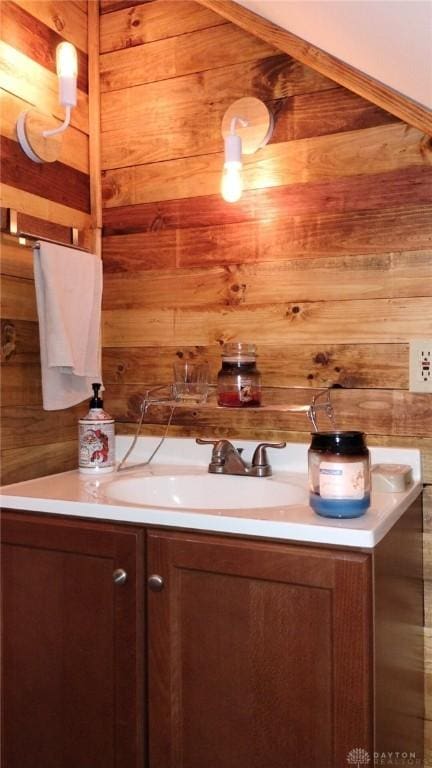 bathroom with vanity and wooden walls