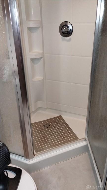 bathroom with a shower with door