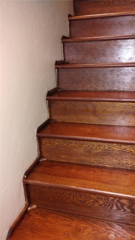 stairs featuring wood-type flooring