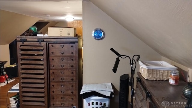 workout area featuring lofted ceiling and hardwood / wood-style floors