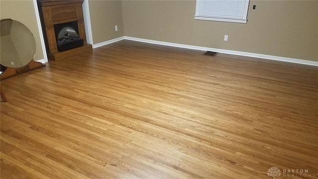 unfurnished living room with light wood-type flooring