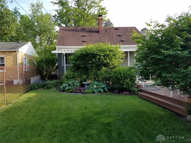 back of property featuring a yard and a deck