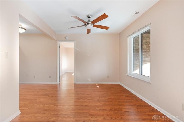 spare room featuring ceiling fan and light wood-type flooring