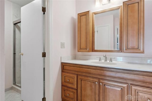 bathroom with vanity and a shower with shower door