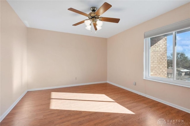 spare room featuring hardwood / wood-style floors and ceiling fan