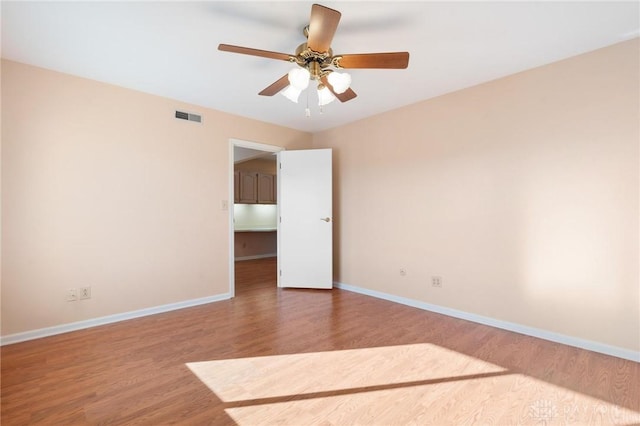 spare room with ceiling fan and hardwood / wood-style floors