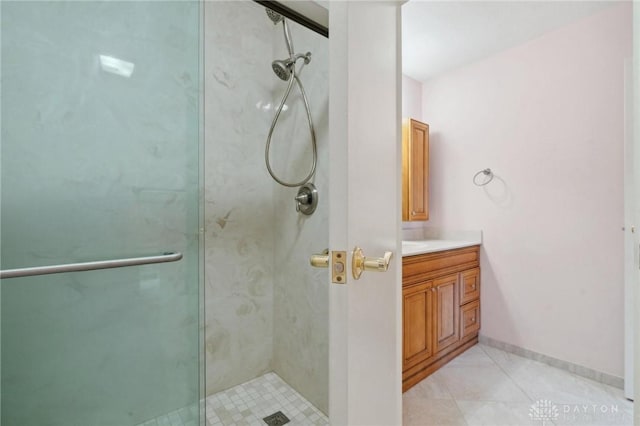 bathroom featuring vanity, tile patterned floors, and walk in shower