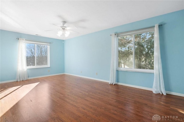 empty room featuring ceiling fan and dark hardwood / wood-style flooring