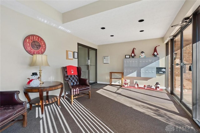 sitting room featuring dark colored carpet