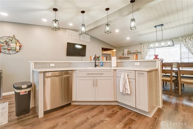 kitchen with dishwasher, a kitchen island, and decorative light fixtures