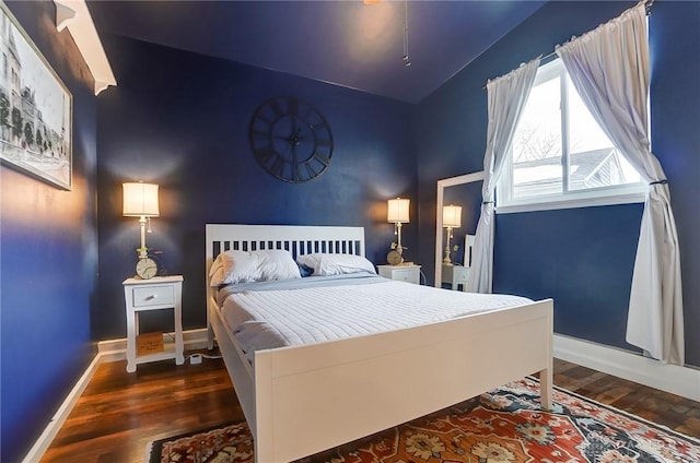 bedroom with dark wood-type flooring