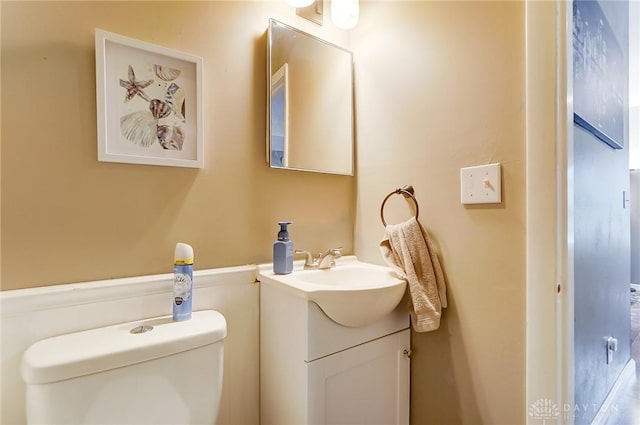 bathroom featuring vanity and toilet