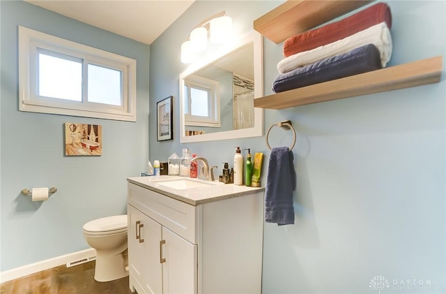 bathroom featuring vanity, toilet, and a shower with shower curtain