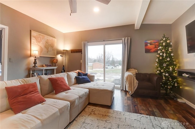 living room featuring dark hardwood / wood-style flooring, vaulted ceiling with beams, and ceiling fan