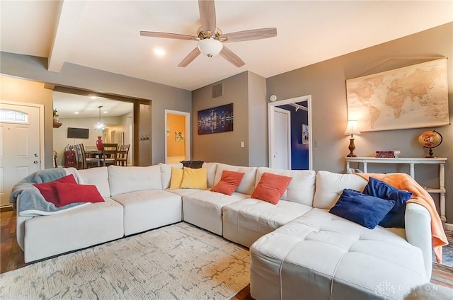 living room featuring beam ceiling and ceiling fan