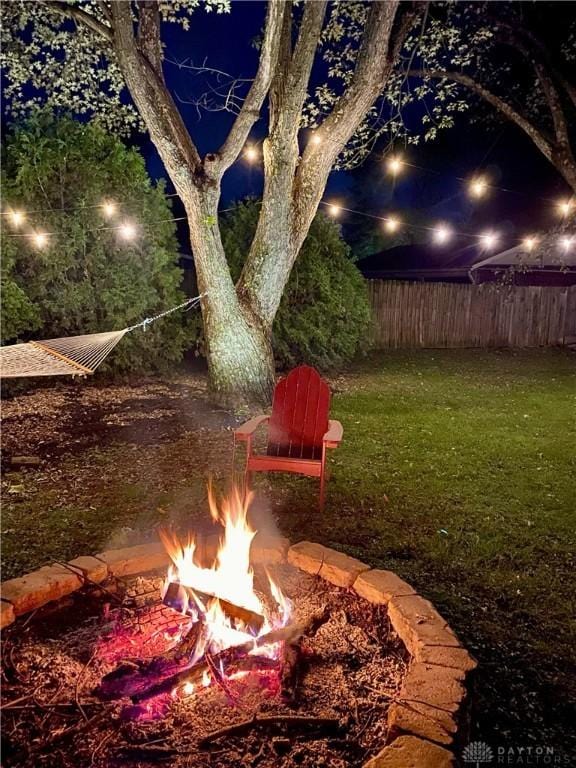 yard at twilight with a fire pit