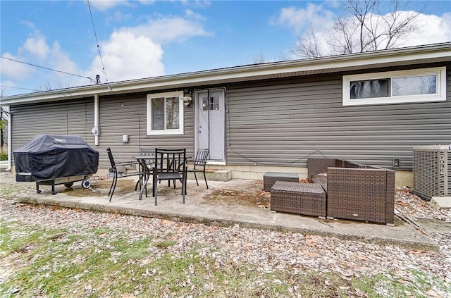 rear view of house with an outdoor living space and a patio area