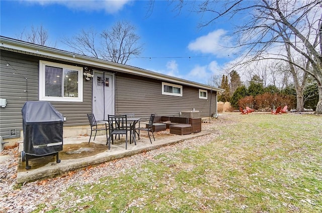 rear view of house with a patio area and a lawn