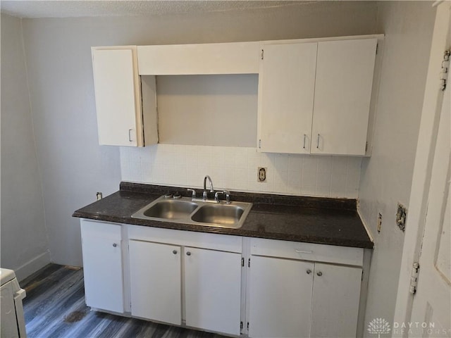 kitchen featuring tasteful backsplash, dark wood-type flooring, sink, and white cabinets