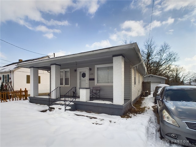 view of front of home with a garage and an outdoor structure