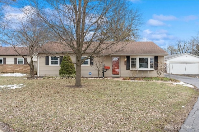 ranch-style house with a garage, an outbuilding, and a front lawn