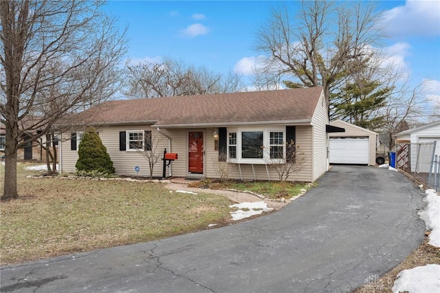 ranch-style house with a garage and a front yard