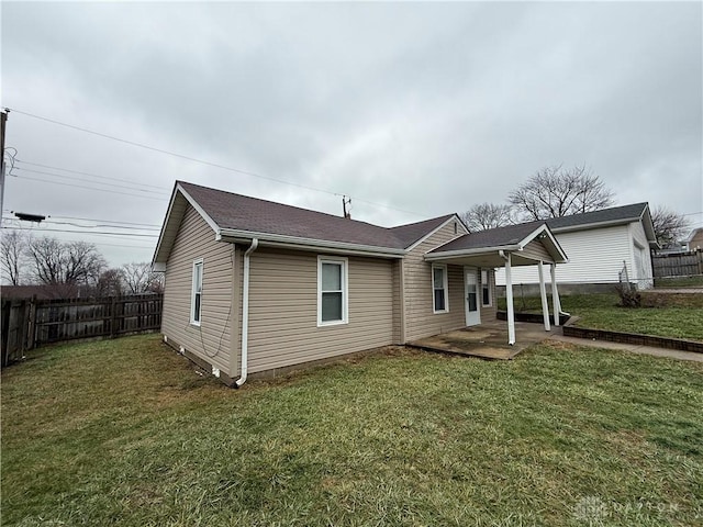 view of front of house with a front yard and a patio area