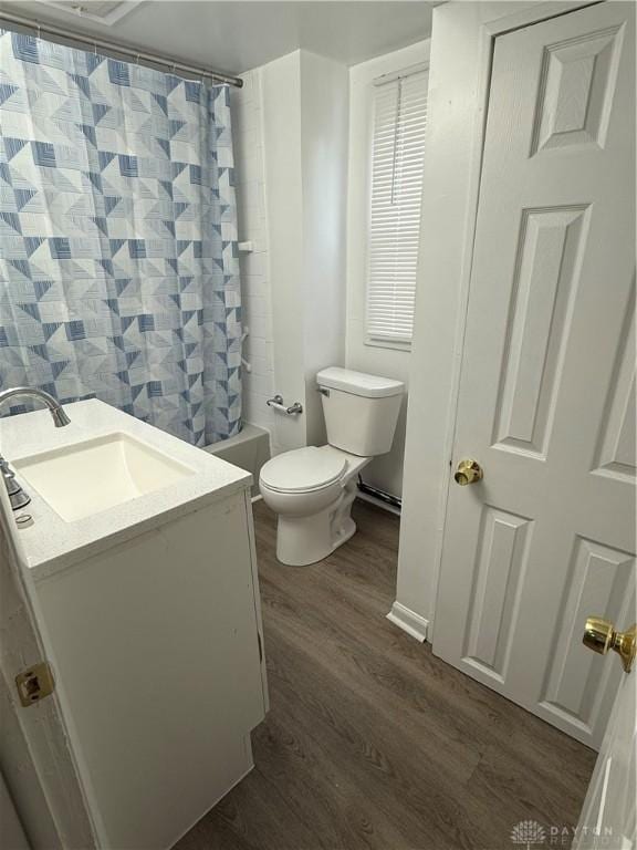 full bathroom featuring vanity, wood-type flooring, toilet, and shower / bath combo with shower curtain