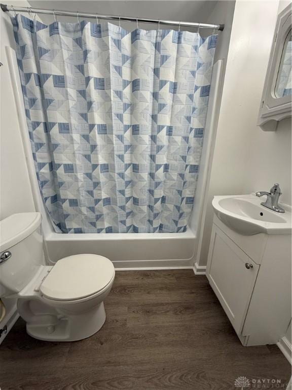 full bathroom with vanity, hardwood / wood-style floors, shower / bath combo, and toilet