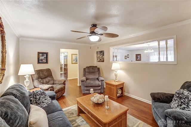 living room featuring hardwood / wood-style flooring, crown molding, and ceiling fan