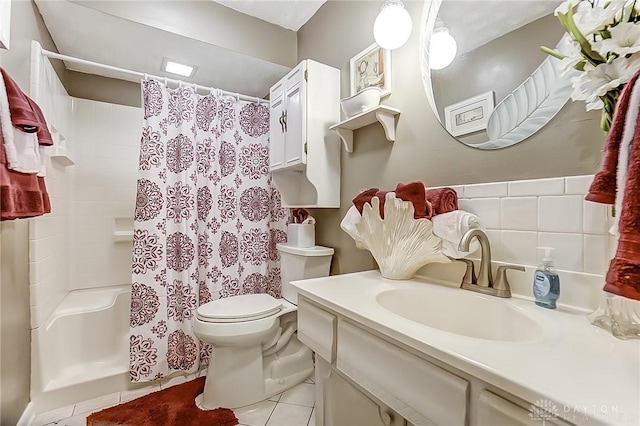 bathroom with tile patterned flooring, vanity, toilet, and walk in shower