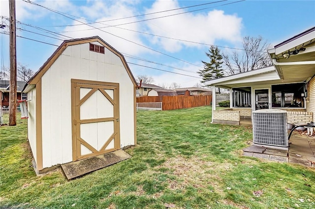 view of yard featuring a storage unit and central air condition unit